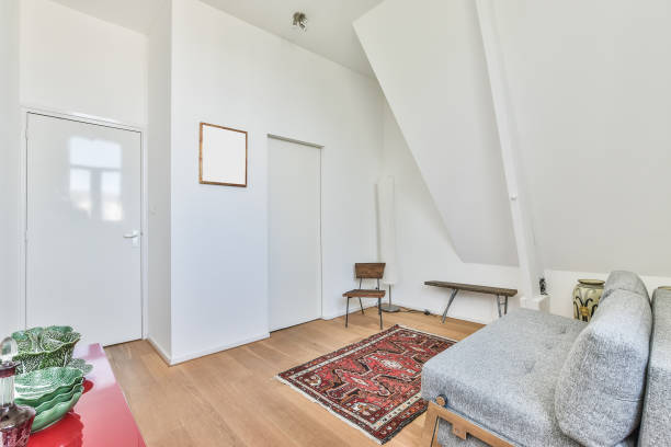istock Modern apartment interior in light colors with a gray sofa and colorful rug 1463390068