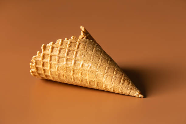istock Textured waffle cone on a brown background isolated, close up. 1463390332