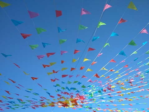 Colourful triangular flyers on blue sky