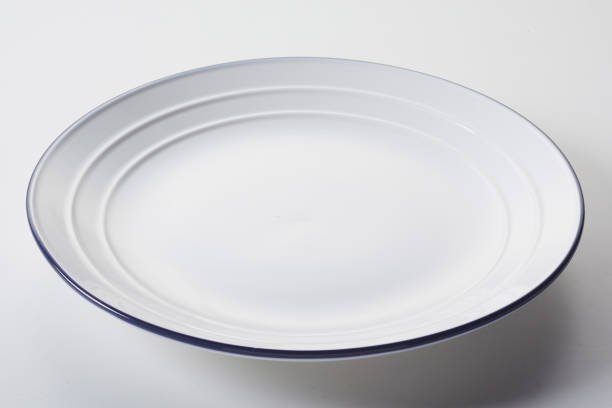 istock White ceramic plate with a ribbed blue brim on white background 1463391154