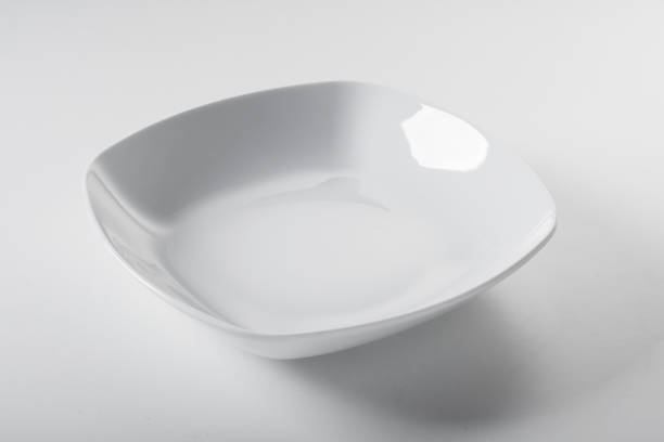 istock Ceramic empty square-shaped white bowl with shiny enamel on white background 1463391163