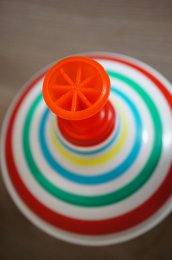 A colorful whirligig toy on a wooden table in children room