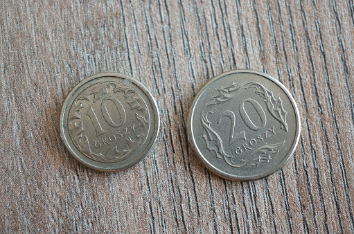 A top v coins on a wooden table