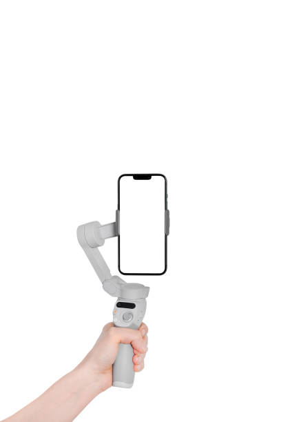 istock New Mobile gimbal hand holding. New generation of electronic stabilizer. Modern Mobile mockup. Vertical banner 1463393349