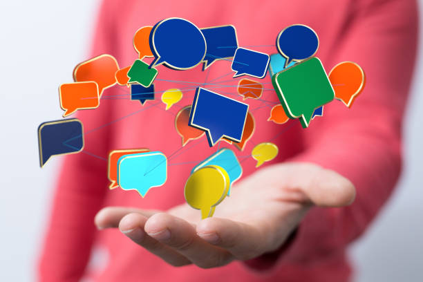 istock Male's hand holding a 3D rendering of speech bubbles, communication concept 1463393430