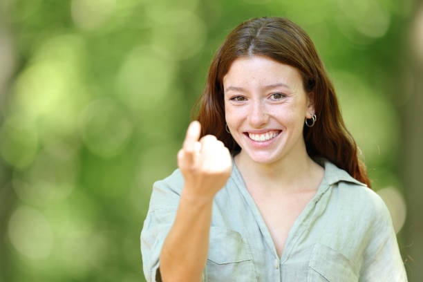 istock Happy woman gesturing come here with finger 1463395317