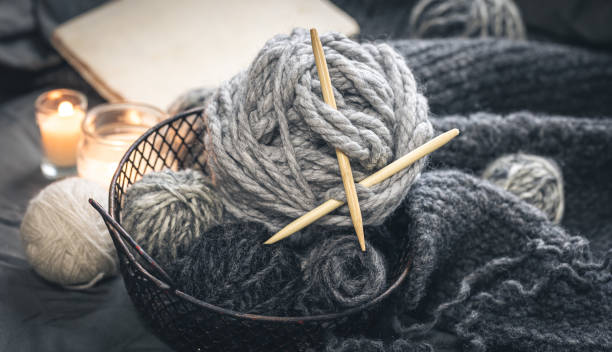istock Close-up, gray threads for knitting, yarn with wooden knitting needles. 1463399133