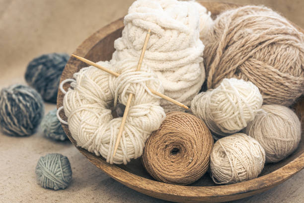 istock Wooden bowl with threads for knitting yarns close-up. 1463399160