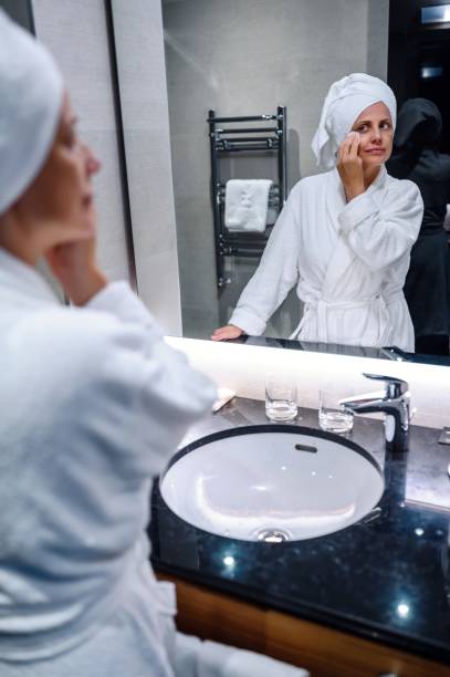 istock Woman in bathrobe cleaning her face 1463399862