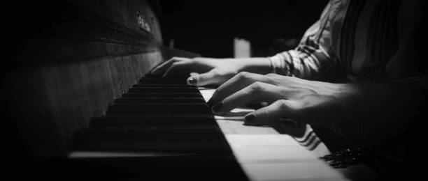 istock Grayscale shot of a man playing piano 1463399908