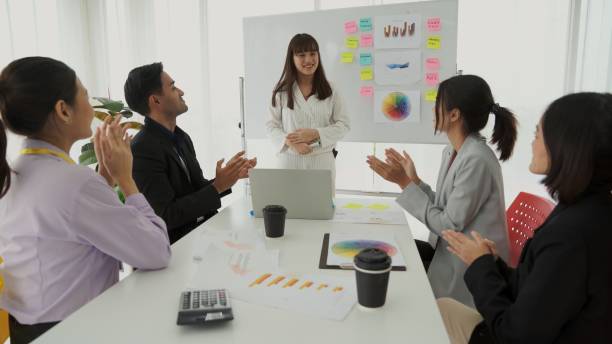 istock Businesswoman proficiently present work project receive celebrations from team . Corporate business team collaboration concept . 1463400291