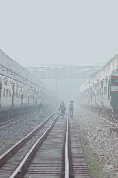 istock Vertical shot of people walking on a railway track 1463402374