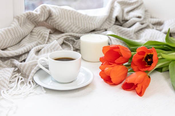 istock Home composition with a cup of coffee, red tulips and a candle. 1463402886