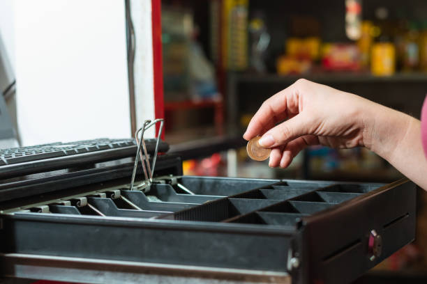 A cashier taking mone from the cash register
