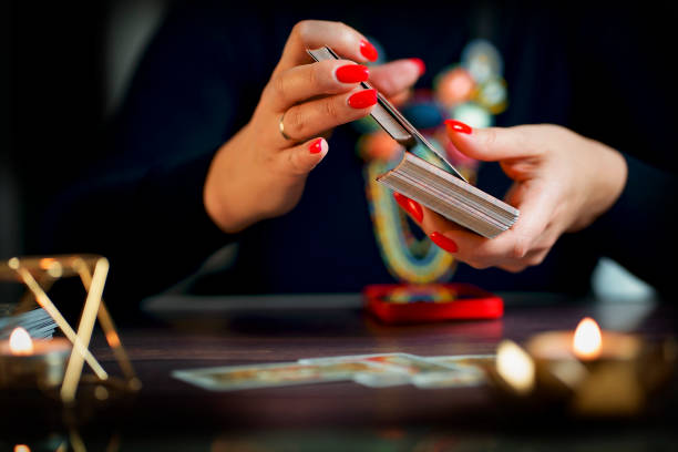 istock two female hands shuffling and adjusting tarot cards. 1463404402
