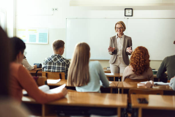 istock Happy female teacher giving a lecture at high school. 1463406384