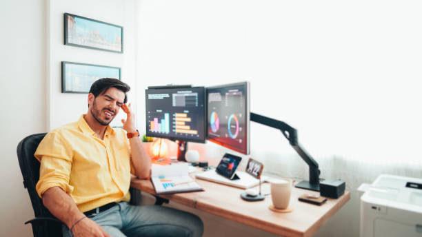 istock Man with migraine working from home 1463408234