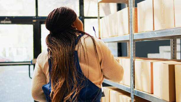 istock Female employee scanning barcodes on packages 1463411080