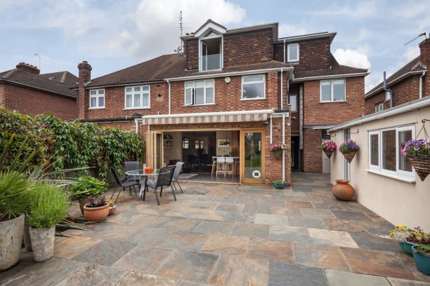 Cambridge, England - June 1 2018: Suburban landscaped patio garden with open bifold doors
