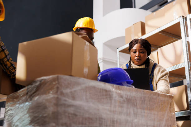 istock Package handlers picking order and packing parcel in warehouse 1463411805