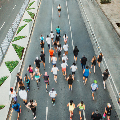 Aerial view of marathon city runners. One person leading marathon.