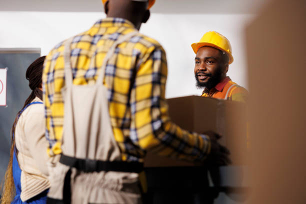 istock Warehouse manager looking at colleague bringing parcel to reception 1463415100