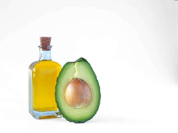 istock Avocado oil with half of avocado fruit 1463418712