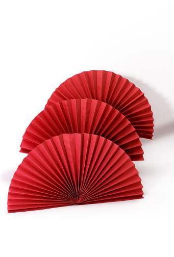 Red circle handmade paper fans on white background. Chinese New Year 2023 background. Copy space