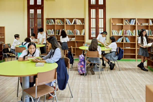Teacher and school children at library