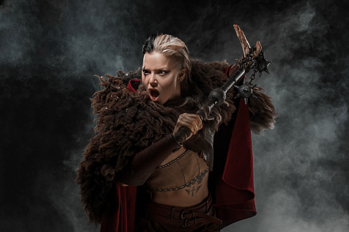 A Beautiful brunette Viking warrior witch woman with an authentic weapon