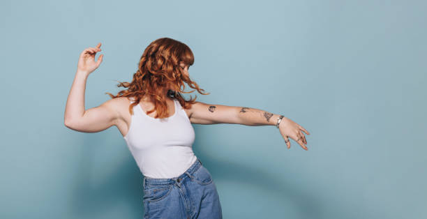 istock Red haired woman dancing in a studio 1463422029