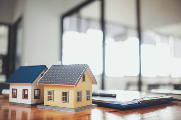 istock Real estate sales documents and model homes are placed on tables inside real estate sales offices to prepare prospective buyers to sign real estate sales contracts with dealers. 1463429559