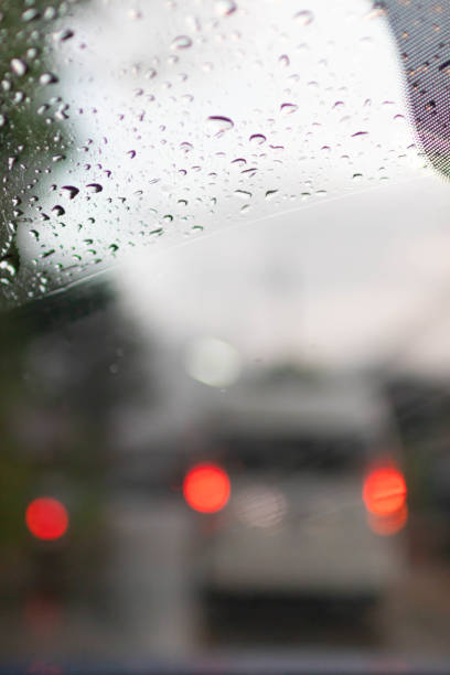 istock Soft Focus,Raindrops on the windshield are raindrops created by a passing storm and affect visibility when driving on the road because raindrops on the windshield make vision difficult. 1463429561