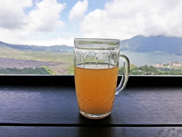 istock Orange juice on the glass, placed on the table with mountain background 1463434547