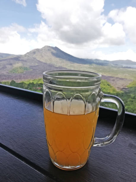 istock Orange juice on the glass, placed on the table with mountain background 1463434548