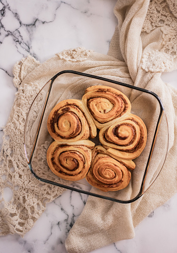 Cinnamon rolls on marbled counter tops