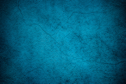 Grunge blue cracked cement wall texture background.