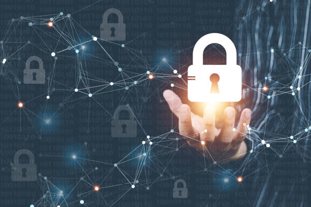 istock cyber security concept Man's hand using a computer showing a padlock icon to show that the smartphone is protected from hackers from hacking, logging in. online trading or use of social media 1463443500