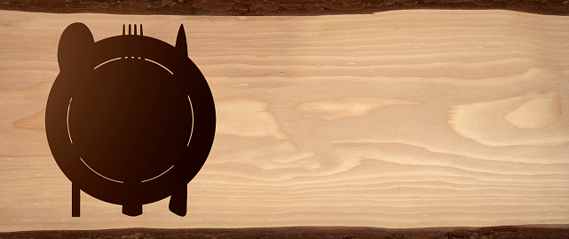 Topview of Set of Plate, Fork and Knife Silhouette on Wood Background