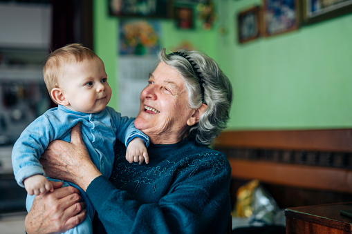 Shot of a happy grandmother embracing little baby grandson.