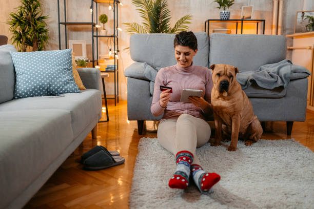 istock Young Woman Shopping Online With Her Dog Using Tablet 1463448406