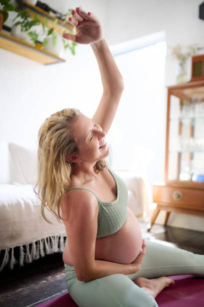 Fitness, happy and stretching with pregnant woman in living room for workout, health and exercise. Wellness, pilates and pregnancy with girl on floor of home for training, relax or focus on maternity