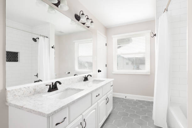 istock A bathroom with a white cabinet, hexagon floor, and subway tile shower. 1463452464