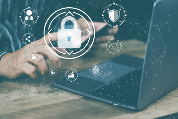 istock cyber security concept Man's hand using a smartphone showing a padlock icon to show that the smartphone is protected from hackers from hacking, logging in. online trading or use of social media 1463452839