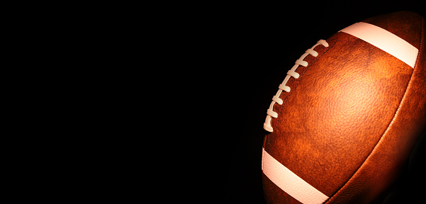 Ball for American football on a black background. USA game. Copy space.