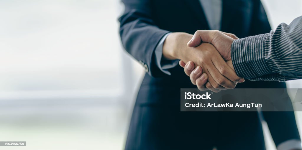 Successful negotiation and handshake concept Two businessmen shake hands with partners to celebrate cooperation and teamwork, mergers and acquisitions. Successful negotiations, business deal concept Handshake Stock Photo