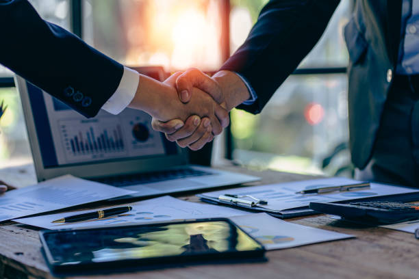 istock Successful negotiation and handshake concept Two businessmen shake hands with partners to celebrate cooperation and teamwork, mergers and acquisitions. Successful negotiations, business deal concept 1463456846
