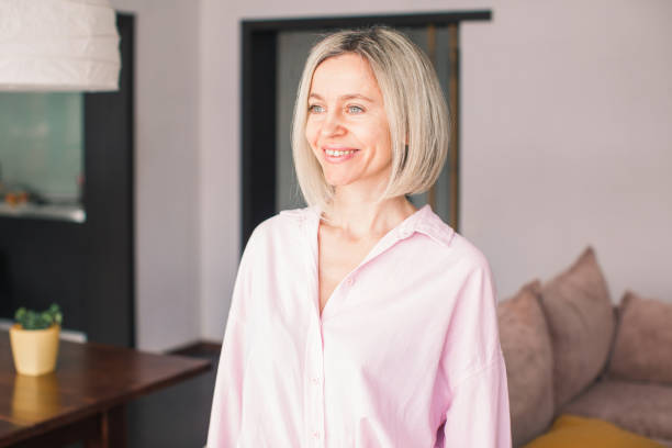 istock Smiling middle aged mature woman looking at camera at home 1463457327