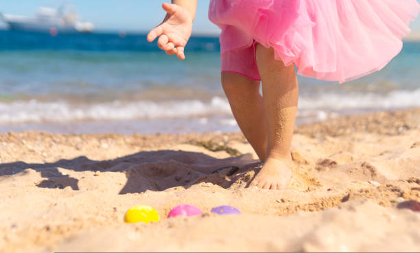 istock Girl hunting for easter eggs on the beach 1463457724