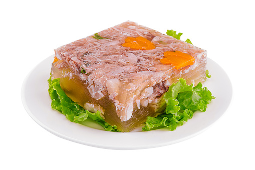 Cold appetizer, portioned jelly of pork, beef and chicken on white plate